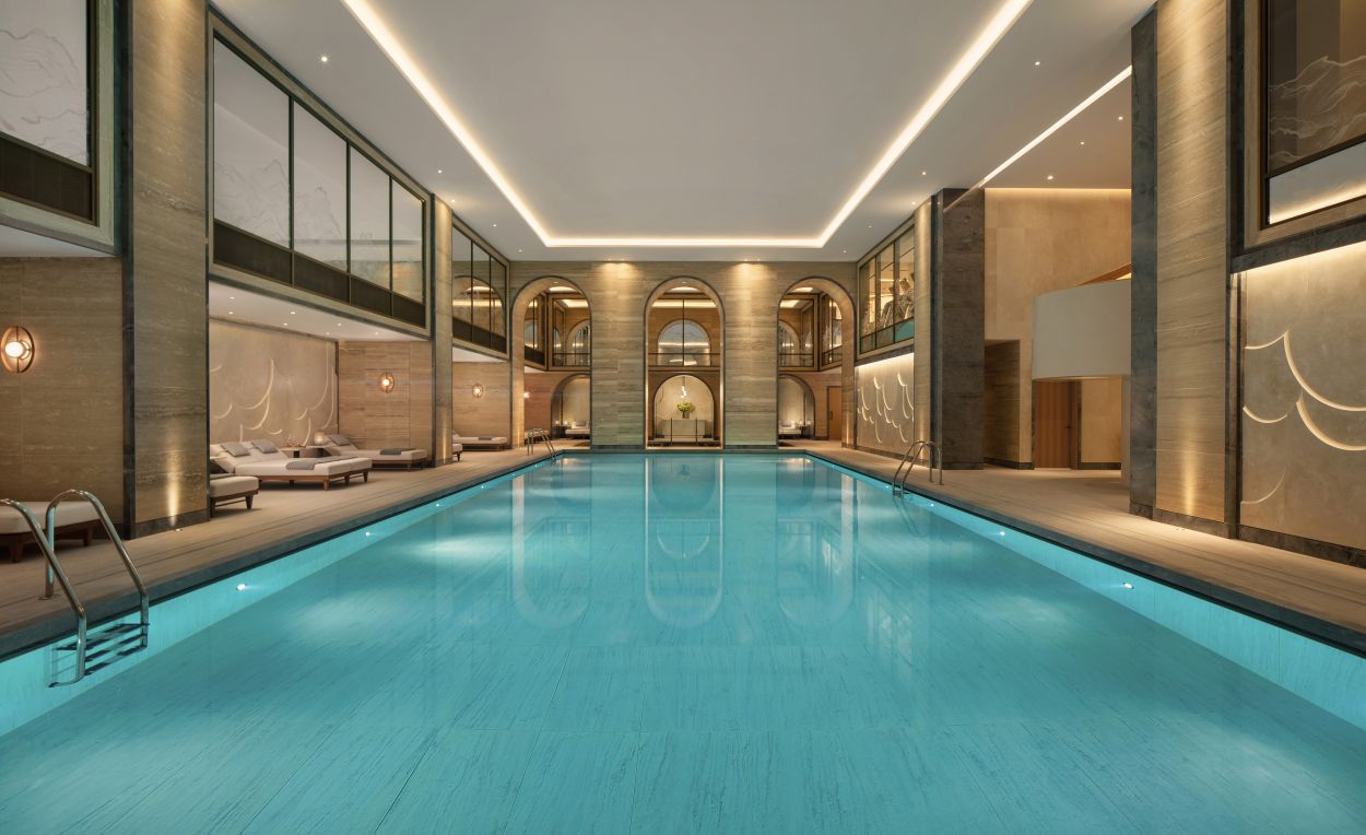 Swimming pool beneath decorated glass screens and mirrors by Peascod.