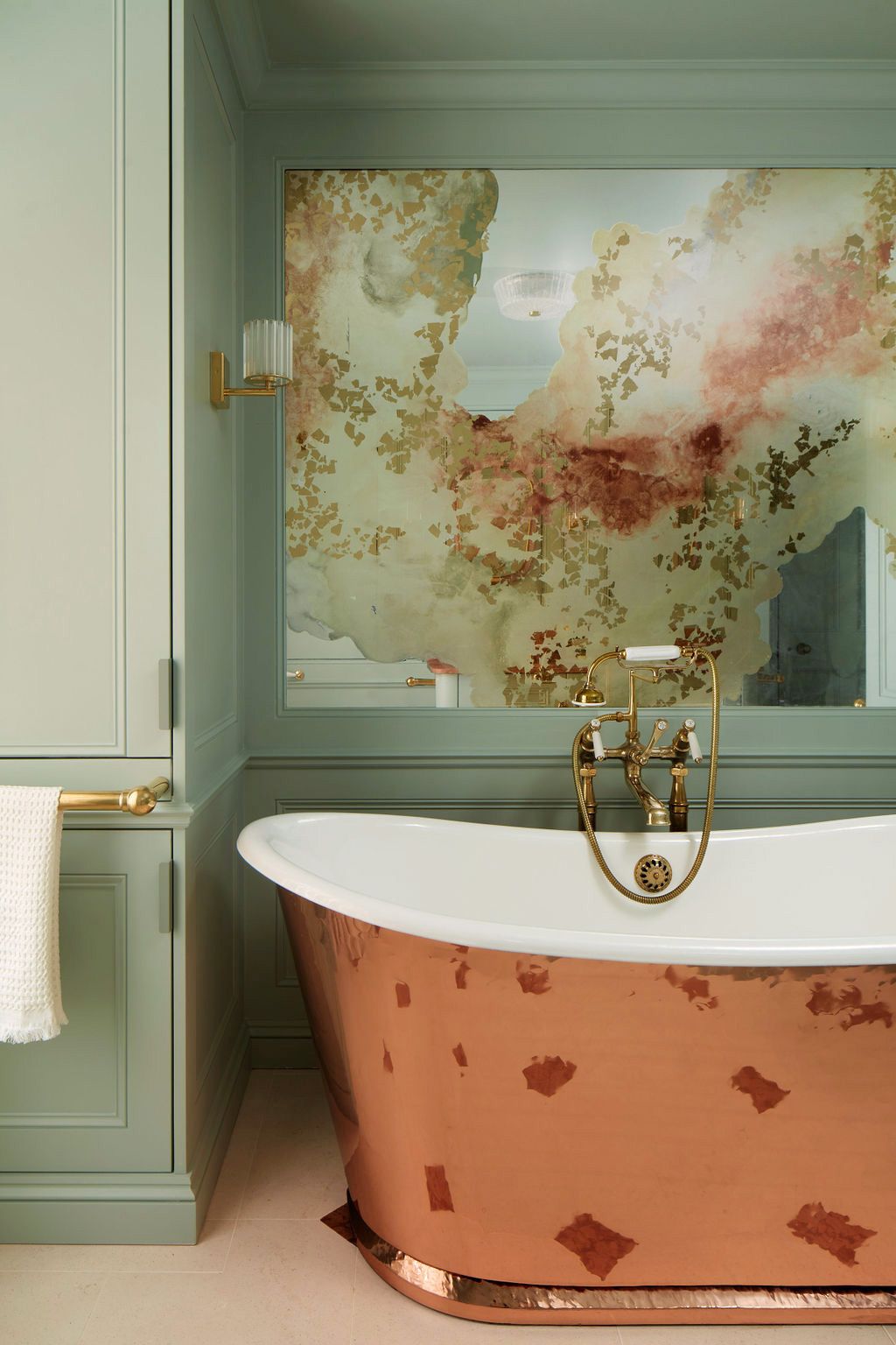 Verre églomisé feature artwork in ensuite bathroom with copper bath by Drummonds.