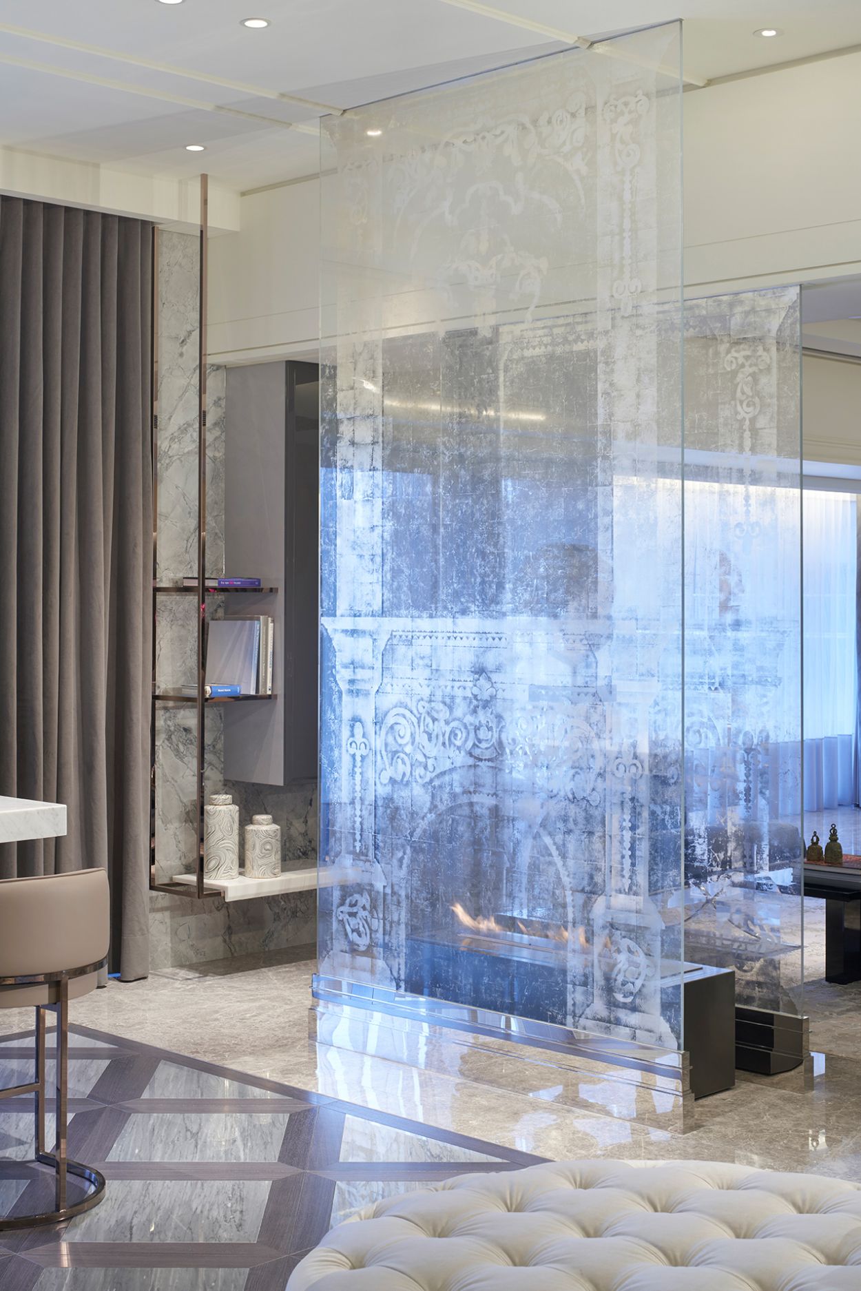 Penthouse apartment with translucent verre églomisé fireplace.