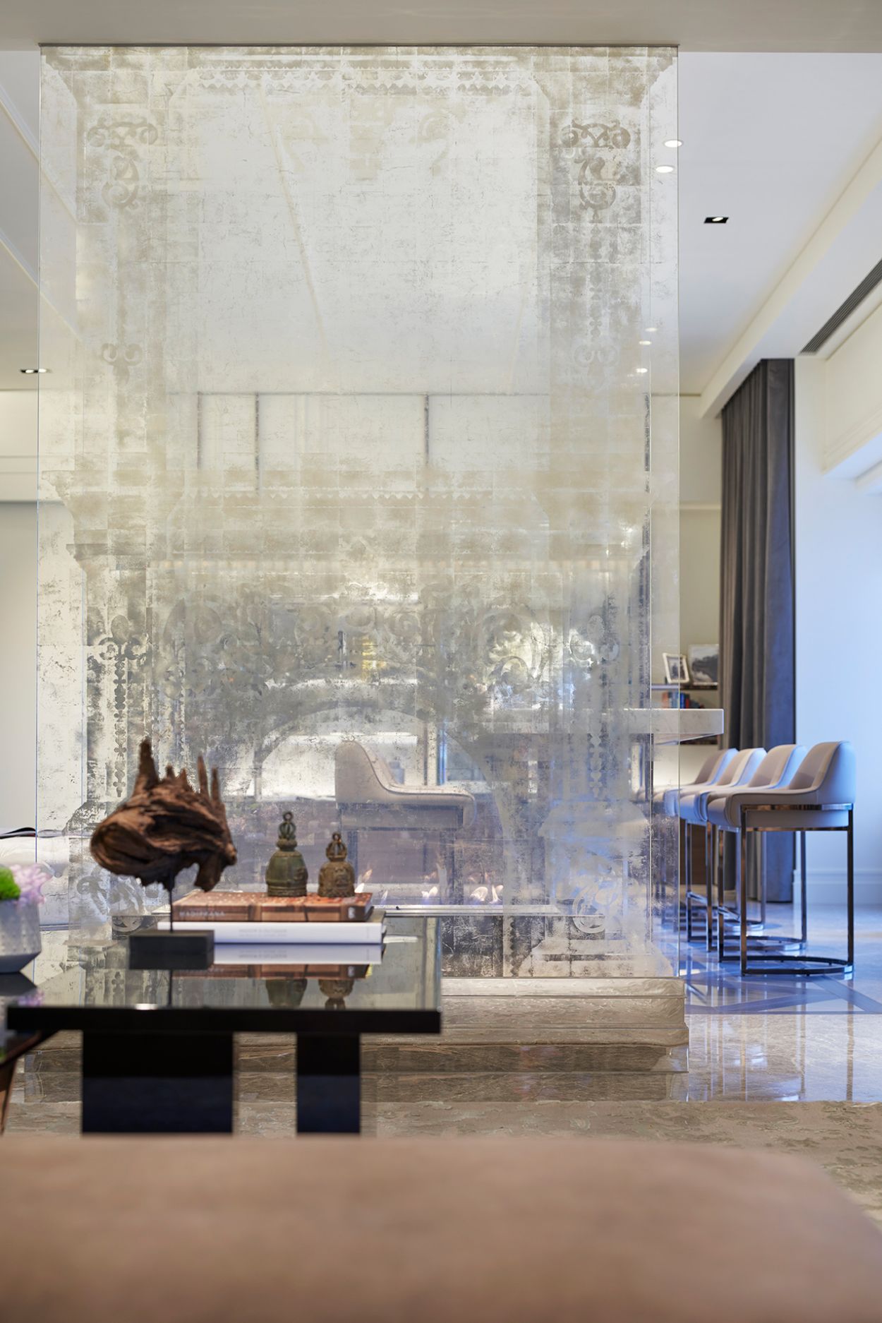 Penthouse apartment with translucent verre églomisé fireplace.