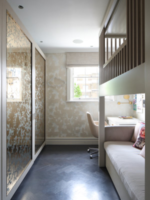 Bronze and gold verre églomisé wardrobe doors in London interior.