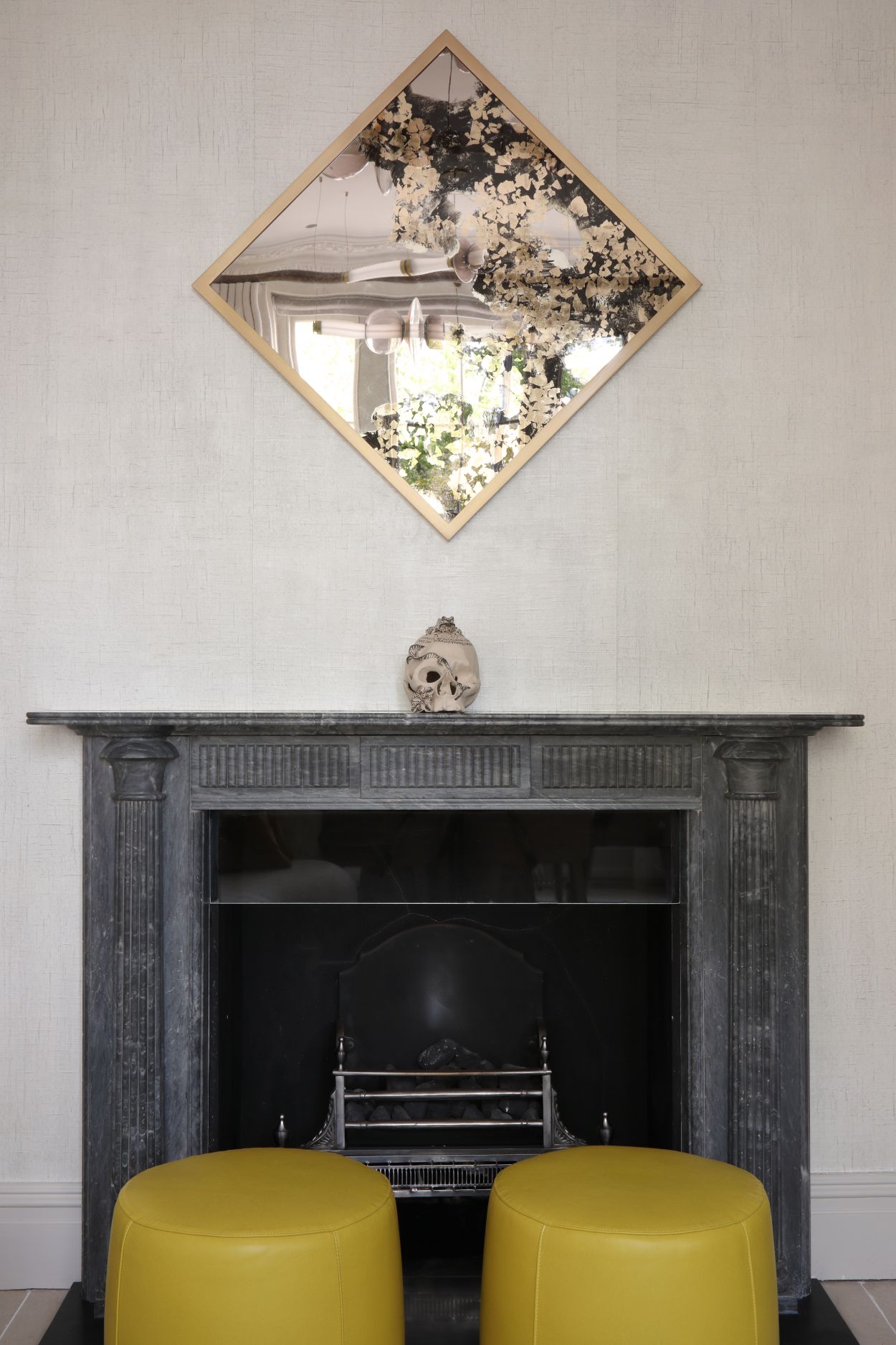 Bronze and gold verre églomisé reflective artwork above fireplace.