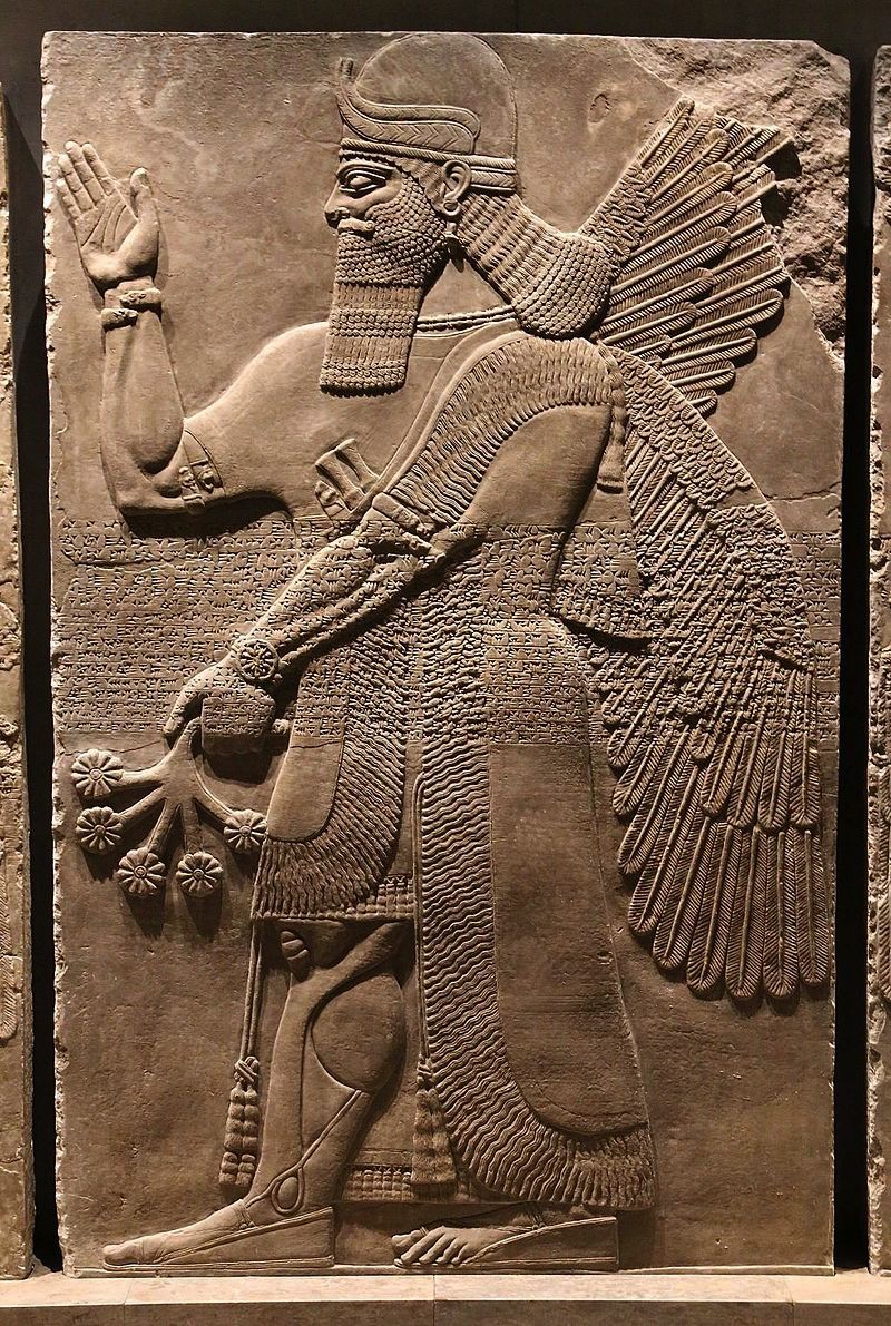 sculpted Assyrian figure with feathers.