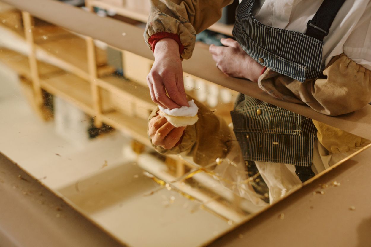 Emma burnishing gold leaf.